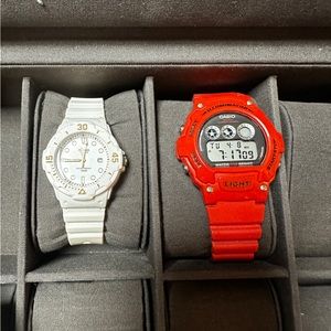 2 Casio watches red digital white analog. The white watch needs a battery.